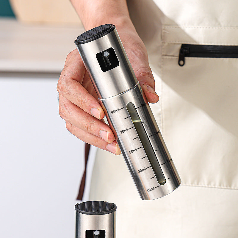 Hand holding the stainless steel oil sprayer