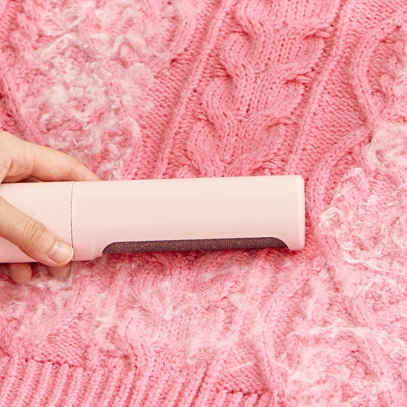 Removing lint from a knitted sweater with the brush