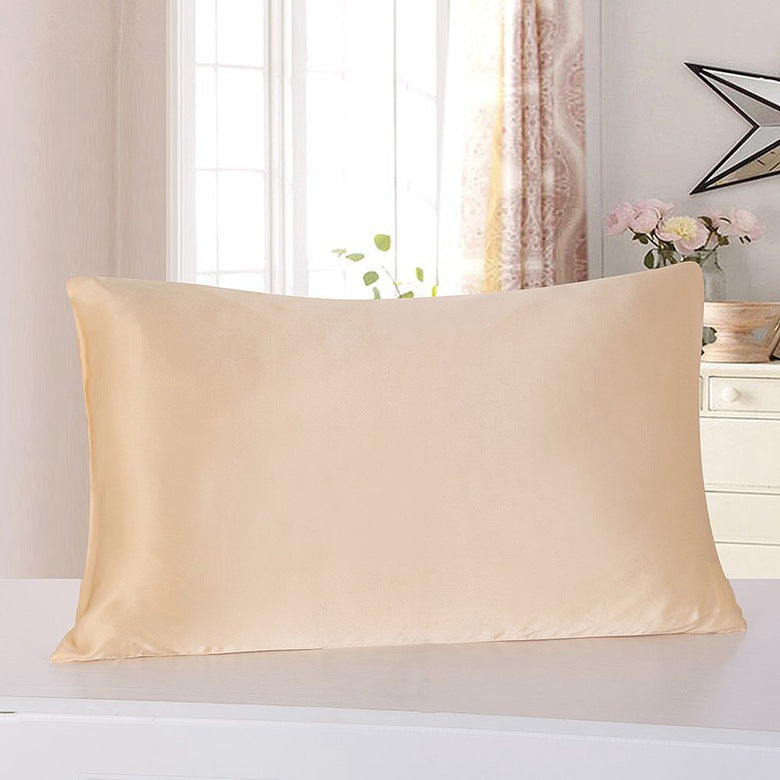 VN Satin Pillowcase in champagne on a bed