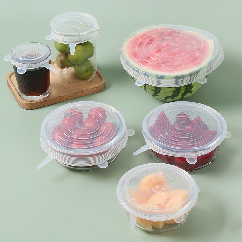 Set of six clear silicone stretch lids covering bowls and cut fruit