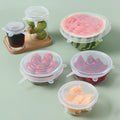 Set of six clear silicone stretch lids covering bowls and cut fruit