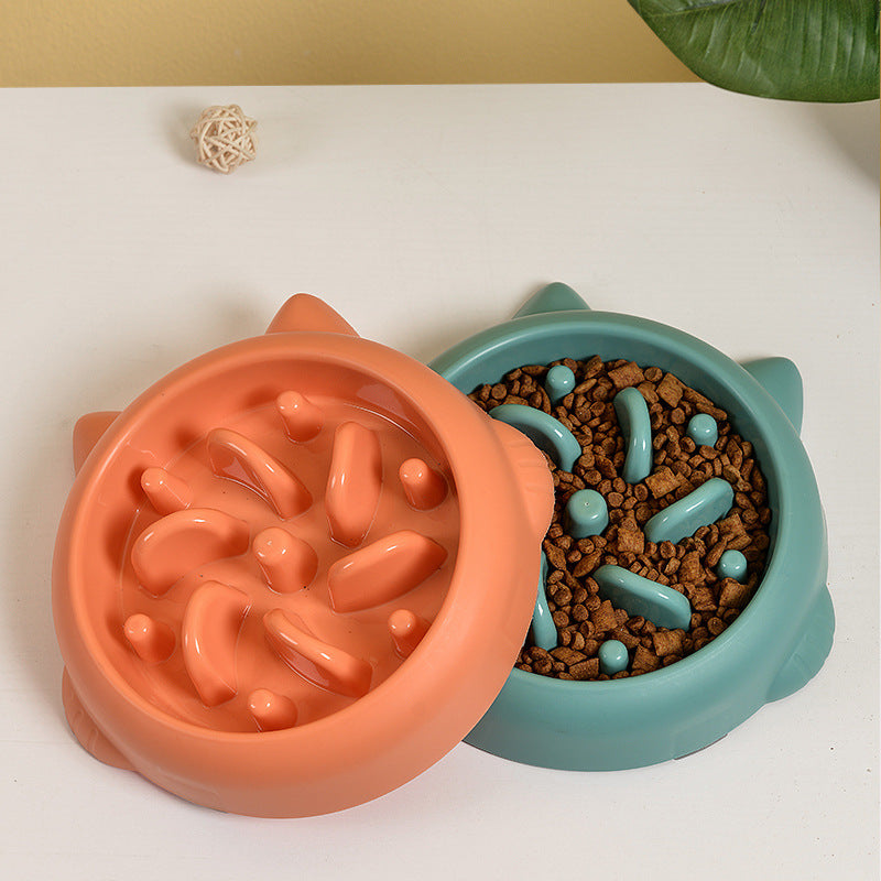 Orange and green slow feeder bowls with kibble