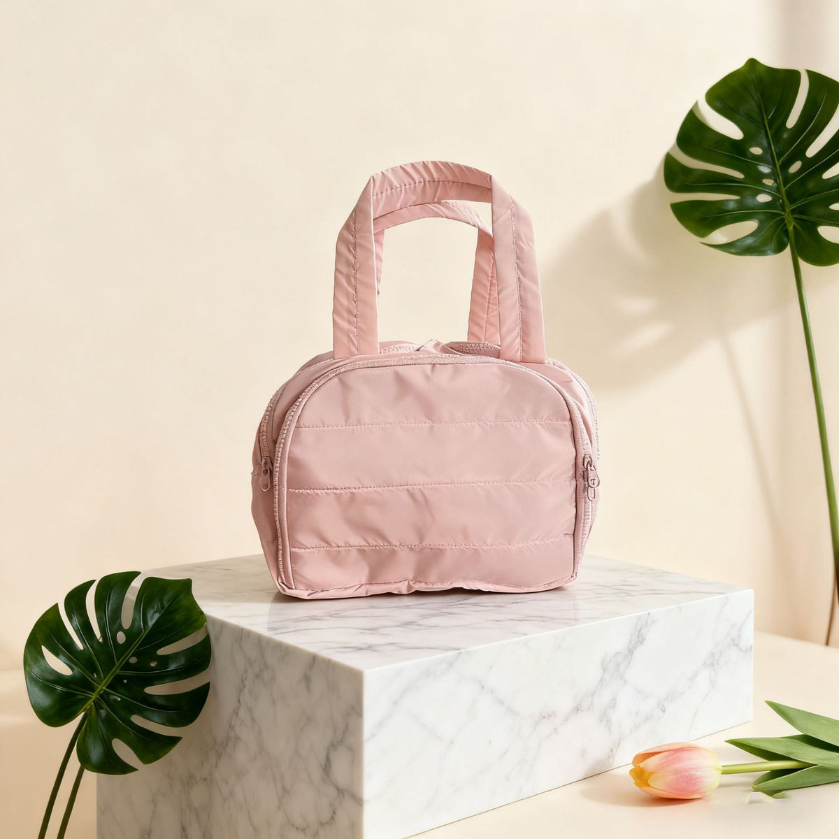 Quilted toiletry bag in pink on a stand